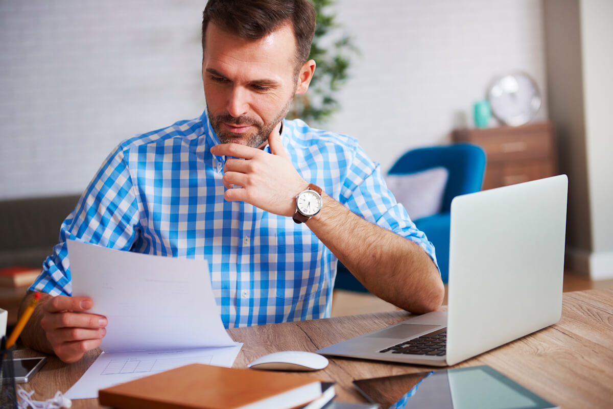 business-person-reading-important-documents-his-desk